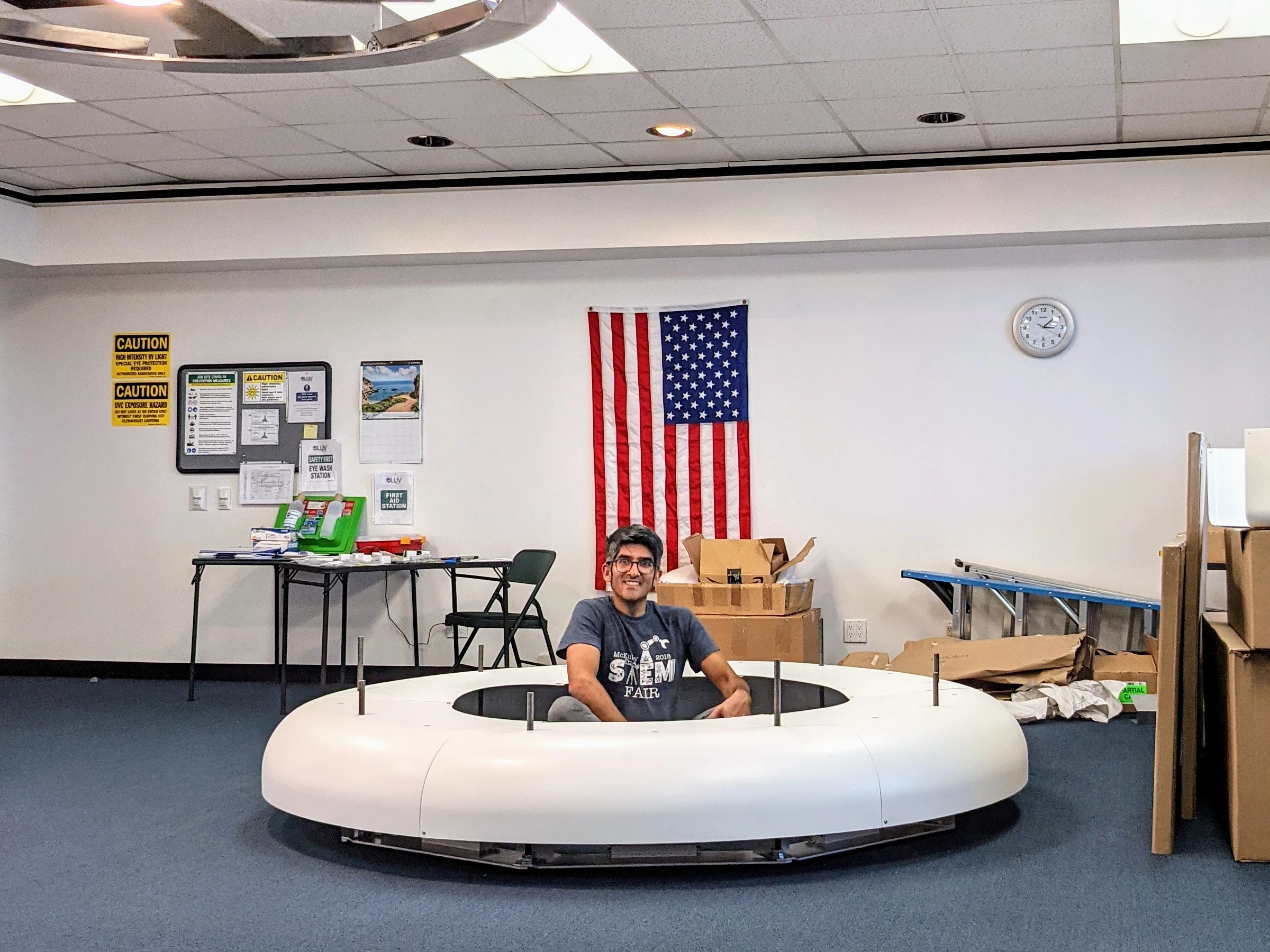 the author, Danish, sitting inside a 9ft wide halo air disinfection system